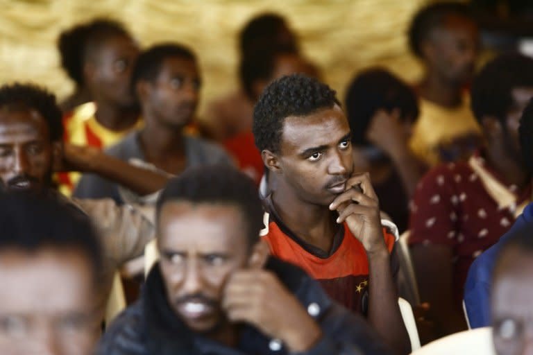 African migrants are gathered in a large tent following a press conference during which Sudanese security forces presented them to journalists at the defence ministry in the capital Khartoum on August 30, 2016