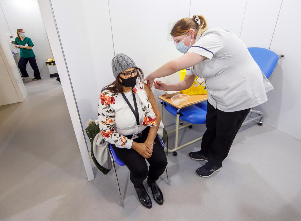 <p>A woman receives an injection of the the Oxford/AstraZeneca coronavirus vaccine at Elland Road vaccine centre in Leeds, as a study shows that people from Asian and minority ethnic (BAME) groups living in deprived communities are more likely to be hesitant about the coronavirus vaccine than those in more affluent areas. Picture date: Friday March 12, 2021.</p>
