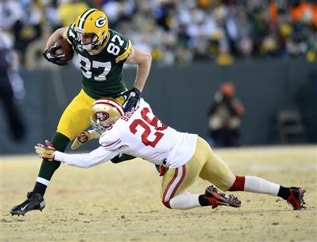 Jan 5, 2014; Green Bay, WI, USA; Green Bay Packers wide receiver Jordy Nelson (87) makes a catch San Francisco 49ers cornerback Tramaine Brock (26) during the second half of the 2013 NFC wild card playoff football game at Lambeau Field. San Francisco 49ers defeat the Green Bay Packers 23-20. Mandatory Credit: Mike DiNovo-USA TODAY Sports