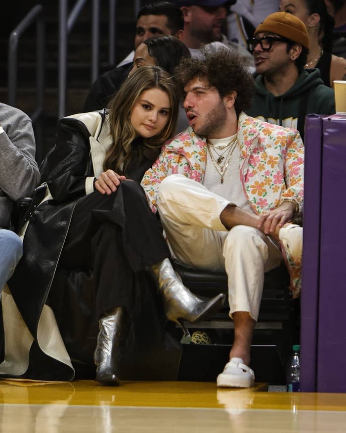 Selena Gomez and Benny Blanco sit courtside at a basketball game