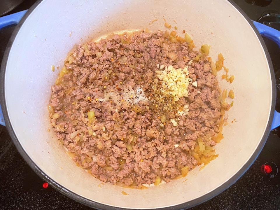 Adding garlic and seasoning for Ina Garten's Rigatoni