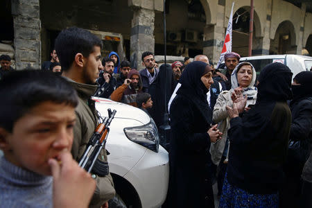 People are seen in the besieged town of Douma, Eastern Ghouta, in Damascus, Syria March 15, 2018. REUTERS/Bassam Khabieh