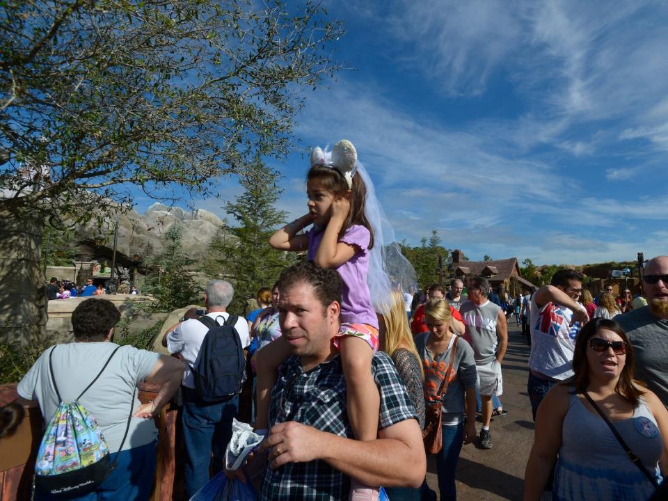 Disney fans walk through Magic Kingdom in Orlando, Florida, on December 6, 2012.