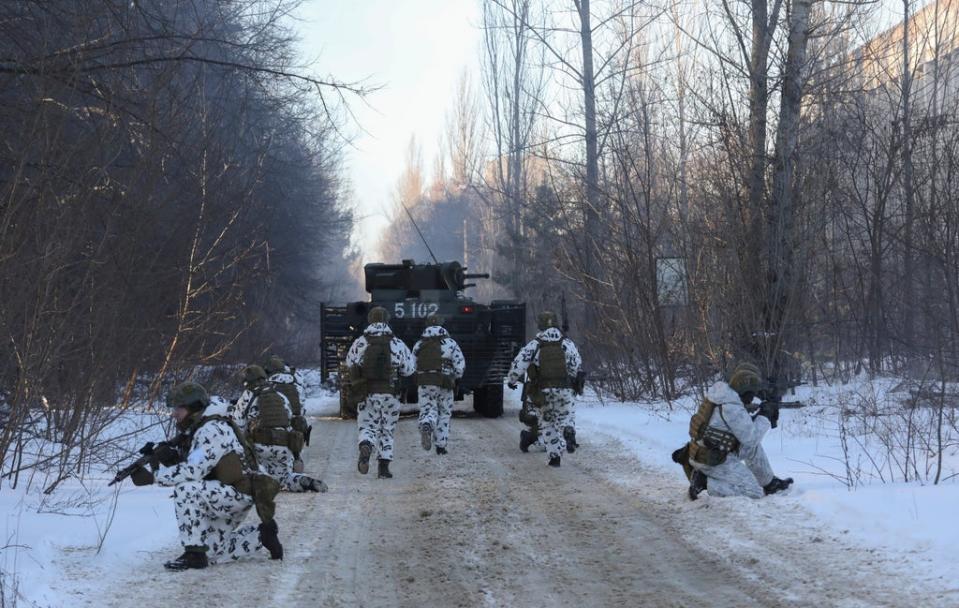 Ukrainian armed forces simulate a crisis situation in an urban settlement in the abandoned city of Pripyat near the Chernobyl plant in the weeks before the Russian invasion (AP)