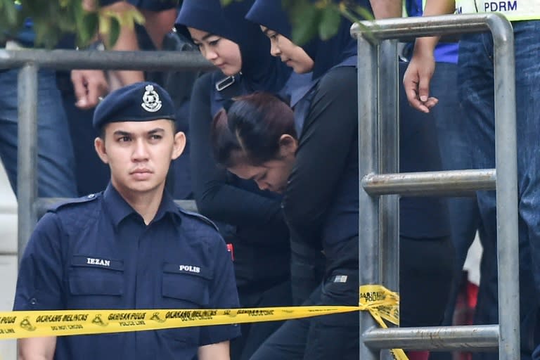 Heavy security for the accused Siti Aisyah (C) and Doan Thi Huong (not pictured) at the pre-trial hearing in Malaysia into the murder of Kim Jong-Nam