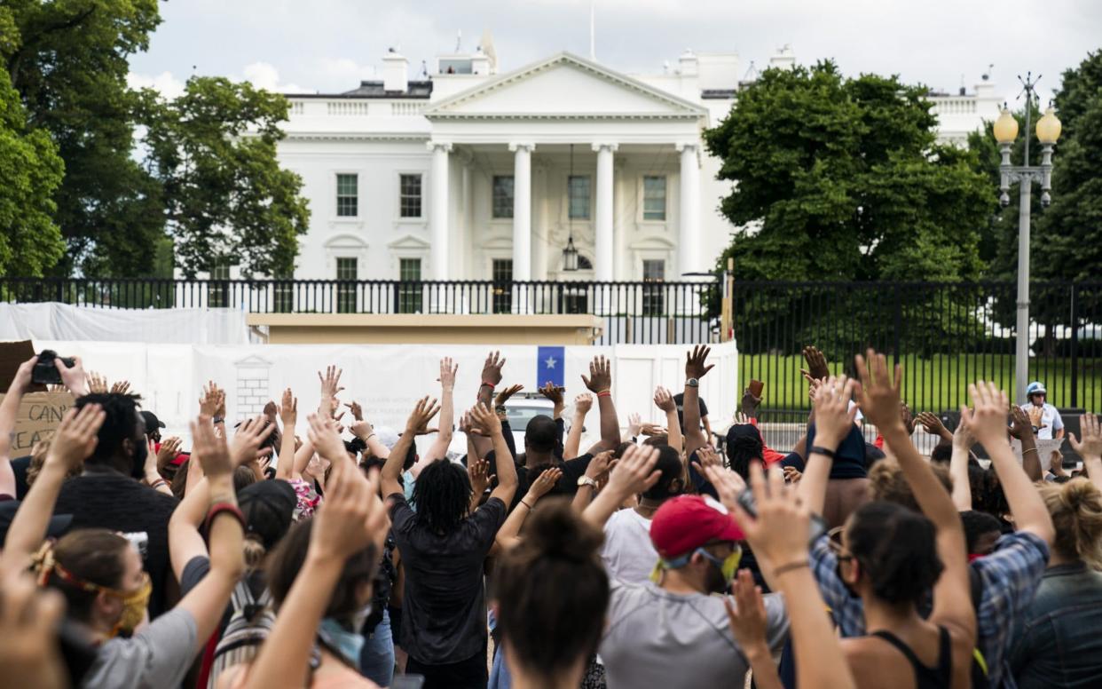 The White House went into lockdown in response to the protest - EPA