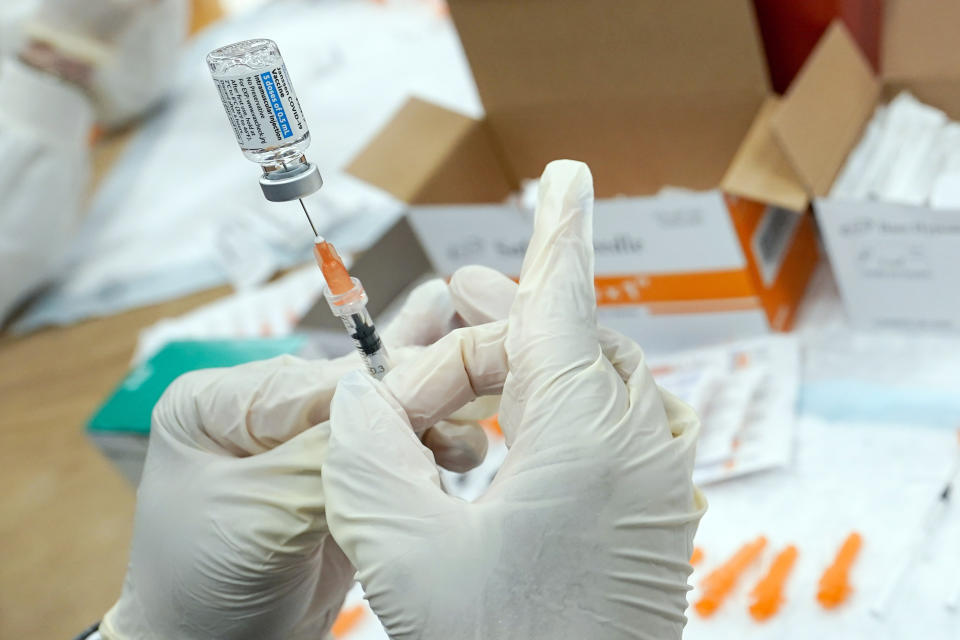 FILE - A registered nurse fills a syringe with the Johnson & Johnson COVID-19 vaccine at a pop-up vaccination site in the Staten Island borough of New York, April 8, 2021. Supreme Court Justice Neil Gorsuch called emergency measures taken during the COVID-19 crisis that killed more than 1 million Americans perhaps “the greatest intrusions on civil liberties in the peacetime history of this country.” The 55-year-old conservative justice pointed to orders closing schools, restricting church services, mandating vaccines and prohibiting evictions in a broadside aimed at local, state and federal officials, even his colleagues. (AP Photo/Mary Altaffer, File)
