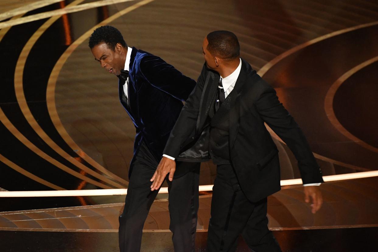 US actor Will Smith (R) slaps US actor Chris Rock onstage during the 94th Oscars at the Dolby Theatre in Hollywood, California on March 27, 2022. (Photo by Robyn Beck / AFP) (Photo by ROBYN BECK/AFP via Getty Images)