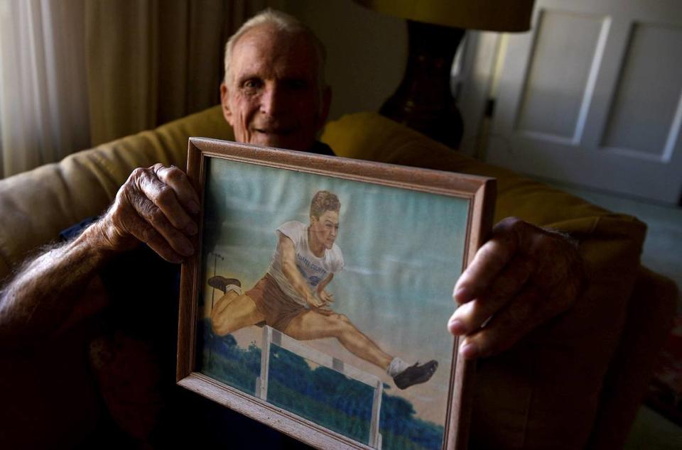 12/06/21—Charles Jones, 93, holds a painting made from a photograph of himself when he was a teen in Manatee High School. He was just 13 when the Japanese bombed Pearl Harbor.