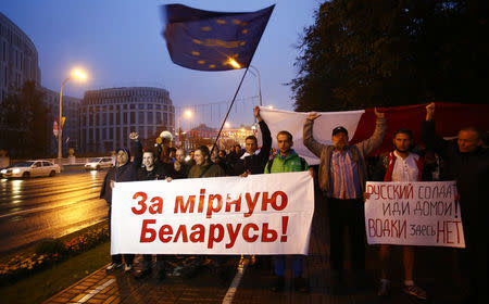 People take part in a procession as they protest against the upcoming Zapad-2017 war games, held by Russian and Belarussian servicemen, and to mark the Day of Belarussian Military Glory in Minsk, Belarus September 8, 2017. The banner (L) reads "For peaceful Belarus". REUTERS/Vasily Fedosenko