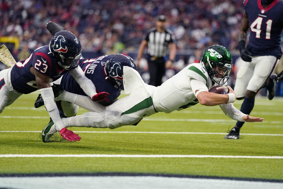 New York Jets quarterback Zach Wilson (2) carries for a touchdown against Houston Texans free safety Eric Murray (23) in the second half of an NFL football game in Houston, Sunday, Nov. 28, 2021. (AP Photo/Eric Smith)