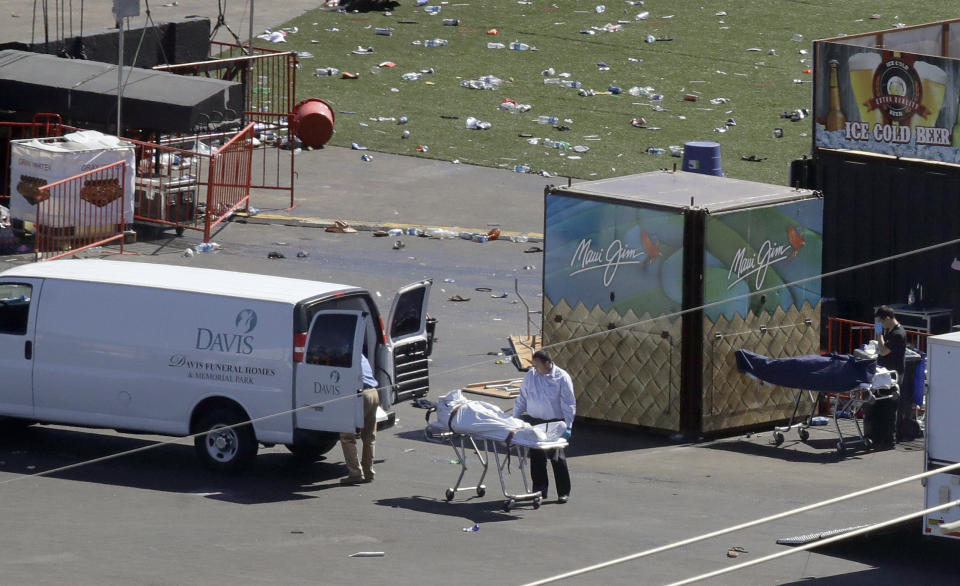 FILE - Investigators load a body from the scene of a mass shooting at a music festival near the Mandalay Bay resort and casino on the Las Vegas Strip, Monday, Oct. 2, 2017, in Las Vegas. Five years after a gunman killed 58 people and wounded hundreds more at a country music festival in Las Vegas in the deadliest mass shooting in modern U.S. history, the massacre is now part of a horrifying increase in the number of mass slayings with more than 20 victims, according to a database of mass killings maintained by The Associated Press, USA Today and Northeastern University. (AP Photo/Chris Carlson, File)