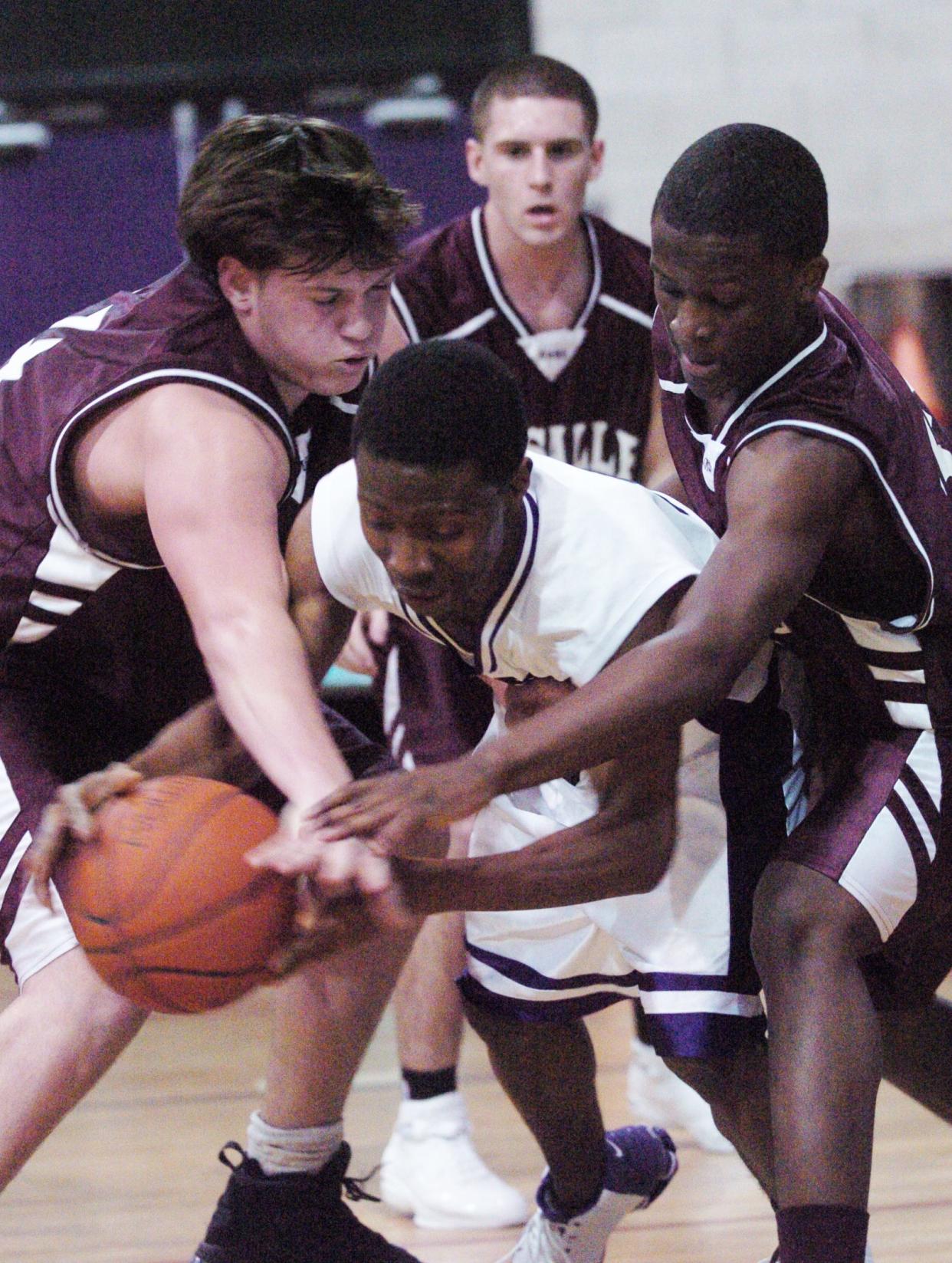 Calvin Jones battles for a loose ball with La Salle teammates and a Classical player during a game in January 2005. Jones went on to play at Johnson & Wales and is now coaching the Moses Brown boys basketball team.