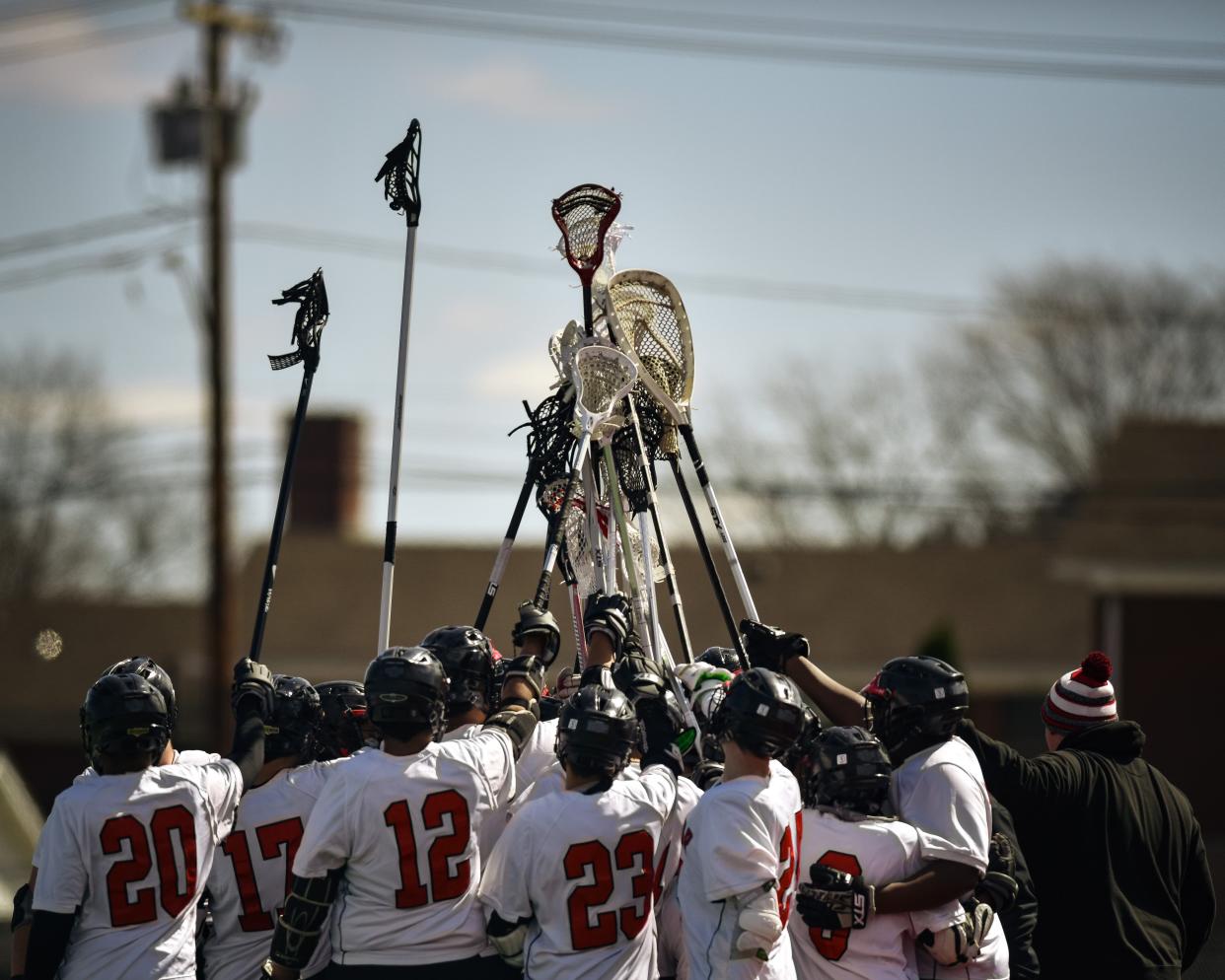 Utica Proctor Raiders huddle before the start of the game at D'Alessandro Stadium in Utica on Saturday, April 2, 2022.