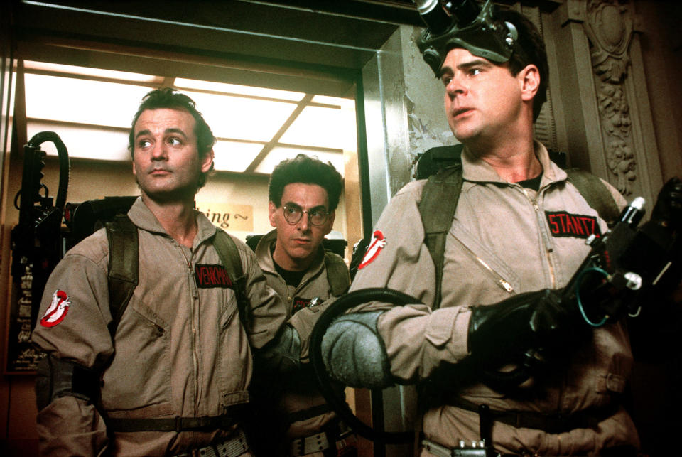 Bill Murray, Harold Ramis, and Dan Aykroyd wear ghostbusters suits