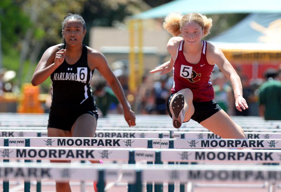 Oaks Christian's Niya Clayton, right, and Fallyn Gowans of Marlborough and compete in the Division 4 girls 100-meter hurdles race during the CIF-Southern Section Track and Field Championships at Moorpark High on Saturday, May 14, 2022. Clayton won the title with a time of 14.78 seconds.