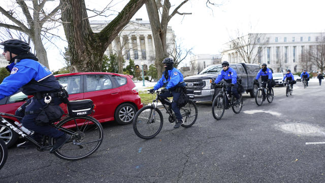 U.S. Capitol Police ride bikes around the Capitol, Thursday, Jan. 6, 2022, in Washington. President Joe Biden and members of Congress are solemnly marking the first anniversary of the Jan. 6 U.S. Capitol insurrection. Lawmakers are holding events Thursday to reflect on the violent attack by supporters of then-President Donald Trump. The ceremonies will be widely attended by Democrats, but almost every Republican on Capitol Hill will be absent. (AP Photo/Julio Cortez)