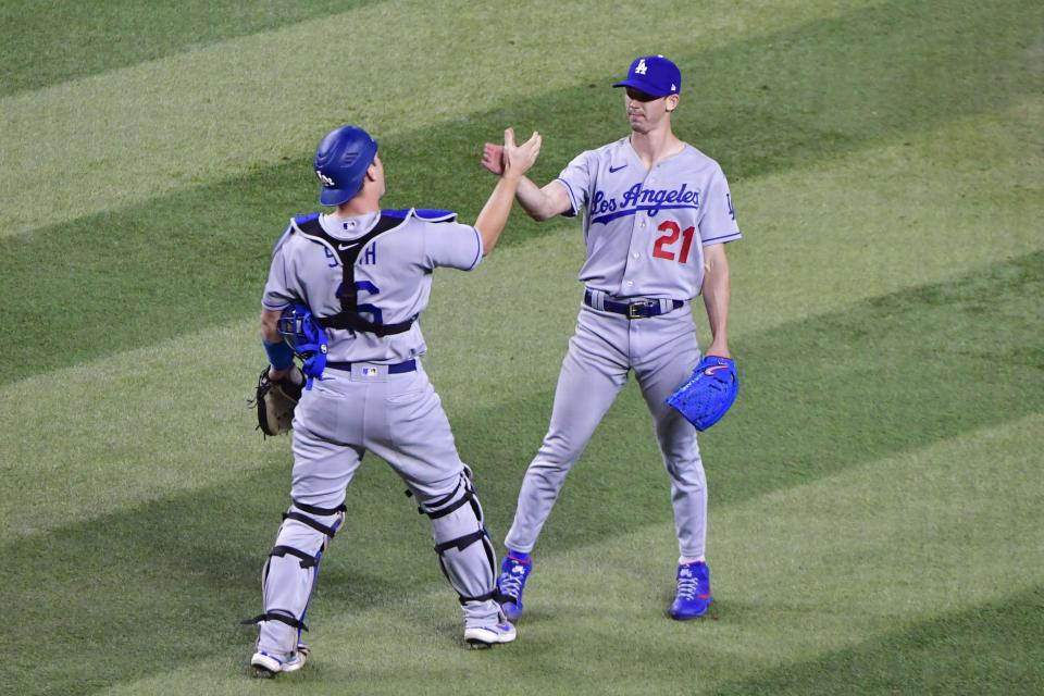 Los Angeles Dodgers starting pitcher Walker Buehler (21) celebrates with catcher Will Smith (16) after throwing his first shutout in a win against the Arizona Diamondbacks.