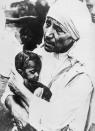 (Original Caption) Mother Teresa, the "Sidewalk Saint" of Calcutta, is shown here with a child in her arms.