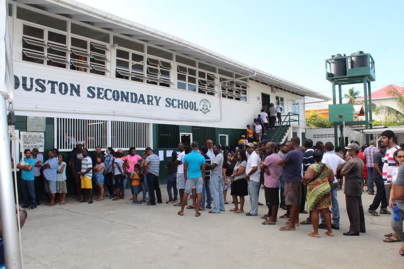 FILE PHOTO: People queue to vote in Guyana's presidential elections in Georgetown