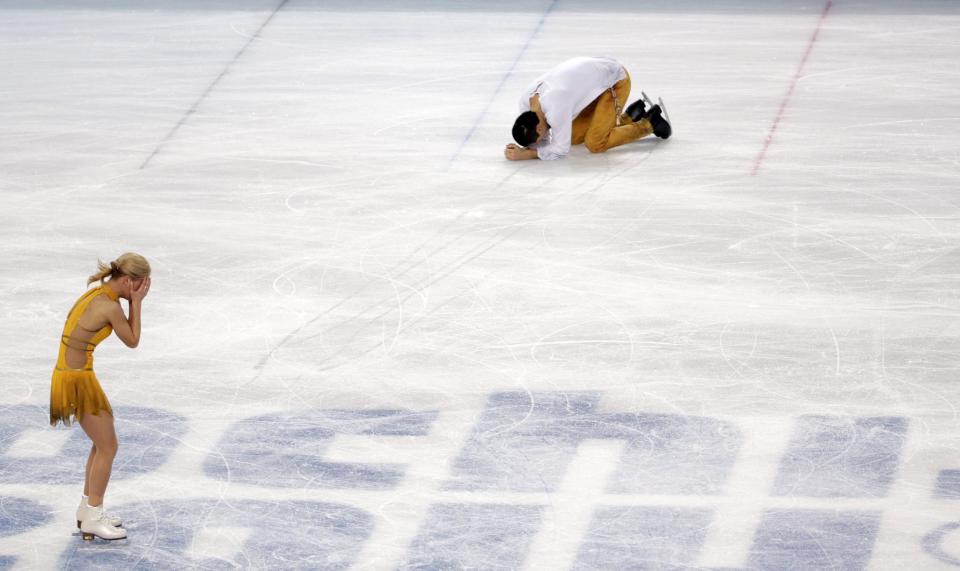 Tatiana Volosozhar and Maxim Trankov of Russia react after finishing their routine in the pairs free skate figure skating competition at the 2014 Winter Olympics, Wednesday, Feb. 12, 2014, in Sochi, Russia. (AP Photo/Bernat Armangue, File)