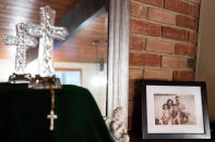 A family photo is displayed in Brenda and Brian Lilly's home, Thursday, Oct. 13, 2022, in Easton, Conn. Brian Lilly Jr., 19, who committed suicide on Jan. 4, 2021, was a rower at University of California San Diego. The Lillys have filed a wrongful death lawsuit against the university and the rowing coach, Geoff Bond, who is no longer with the school. (AP Photo/Julia Nikhinson)