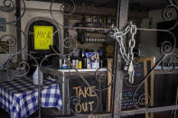 The doors of the Baby Blues BBQ restaurant are seen locked in Los Angeles Monday, Jan. 25, 2021. California has lifted regional stay-at-home orders statewide in response to improving coronavirus conditions. Public health officials said Monday that the state will return to a system of county-by-county restrictions intended to stem the spread of the virus. Local officials could choose to continue stricter rules. The state is also lifting a 10 p.m. to 5 a.m. curfew. (AP Photo/Damian Dovarganes)