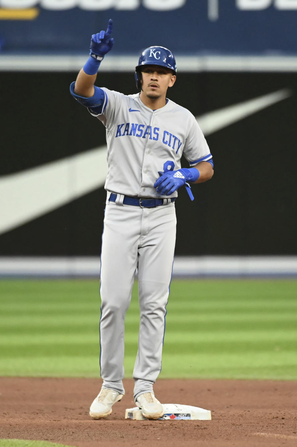 Kansas City Royals' Nicky Lopez gestures to the dugout after hitting a double against the Toronto Blue Jays during the fifth inning of a baseball game Thursday, July 14, 2022, in Toronto. (Jon Blacker/The Canadian Press via AP)