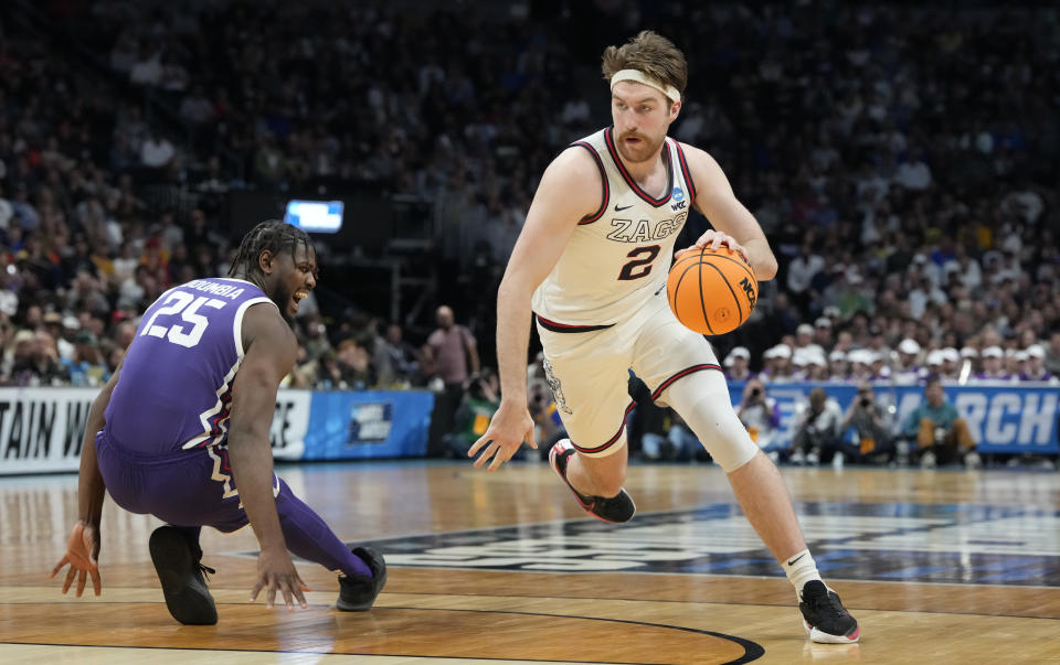 Gonzaga forward Drew Timme, right, drives the lane past TCU center Souleymane Doumbia in the second half of a second-round college basketball game in the men's NCAA Tournament Sunday, March 19, 2023, in Denver. (AP Photo/David Zalubowski)