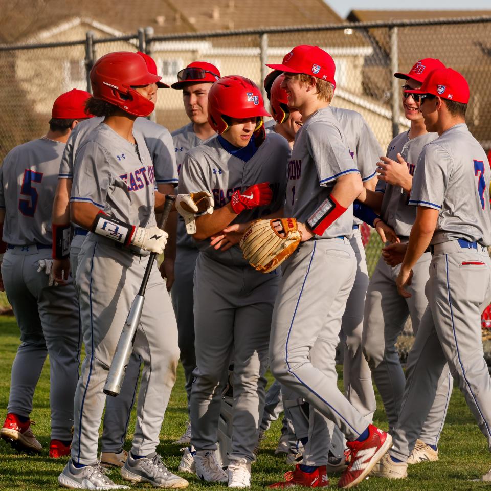 East Union’s Ryan Guibor is surrounded by teammates after hitting an inside-the-park home run during a game between Weston Ranch and East Union High at Weston Ranch High School in Stockton, CA