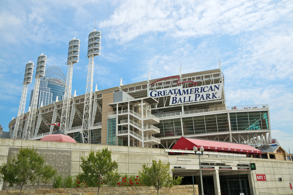 Gate 1 and exterior of Great American Ball Park, Cincinnati, home of the Cincinnati Reds with blue and white cloud sky and a few buildings in the background