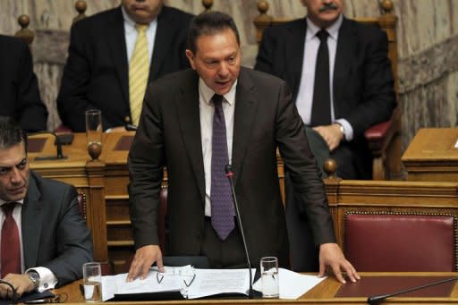 Greek finance minister Yiannis Stournaras gives a speech at the Greek parliament in Athens. The coalition government of Antonis Samaras won the largely symbolic confidence vote, winning a comfortable mandate to tackle the country's two-year-old crisis
