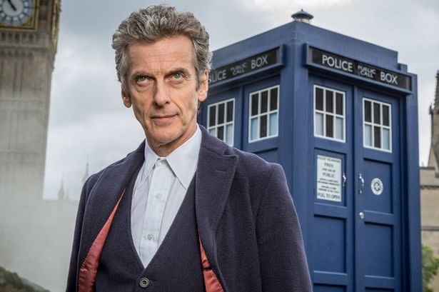 Peter Capaldi as the Doctor, with the TARDIS in the background