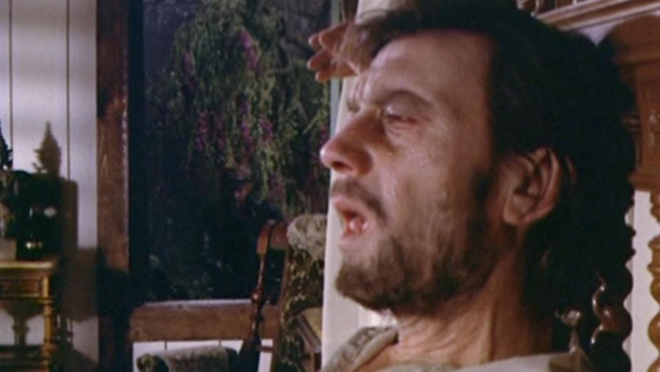Laurence Harvey sits on a bed in horrible agony in Night Gallery.