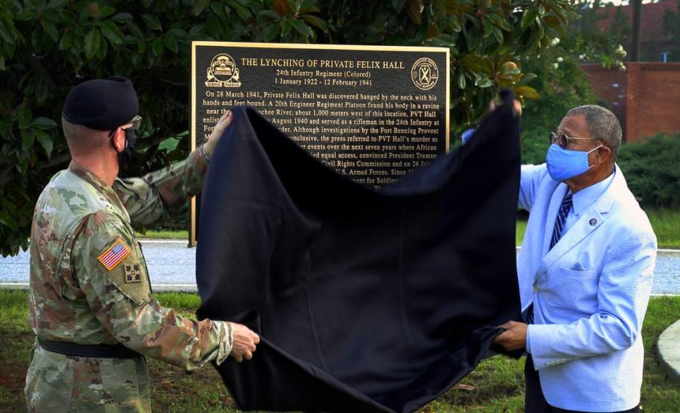 U.S. Army Lt. Gen. Theodore D. Martin, left, and U.S. Rep. Sanford D. Bishop, D-GA,right, unveil a historic marker about the lynching of U.S. Army Private Felix Hall in 1941. The marker is near the location where Hall was last seen on Feb. 12, 1941. 08/03/2021