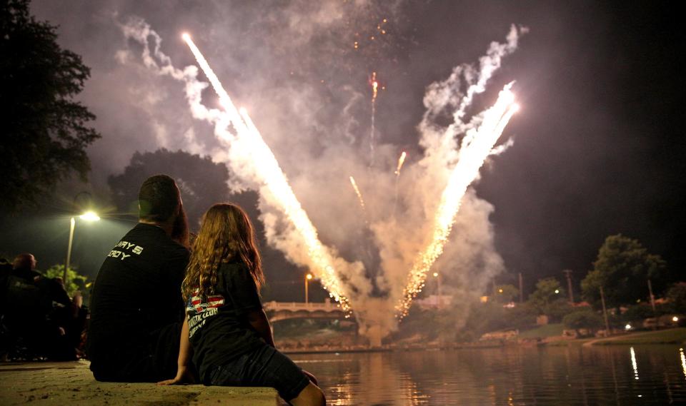 People gather along the Concho River to watch fireworks during the Star Spangled Concert and Fireworks event Saturday, July 3, 2021.