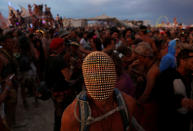 <p>A participant wears a mask as he dances as approximately 70,000 people from all over the world gathered for the annual Burning Man arts and music festival in the Black Rock Desert of Nevada, Aug. 29, 2017. (Photo: Jim Urquhart/Reuters) </p>