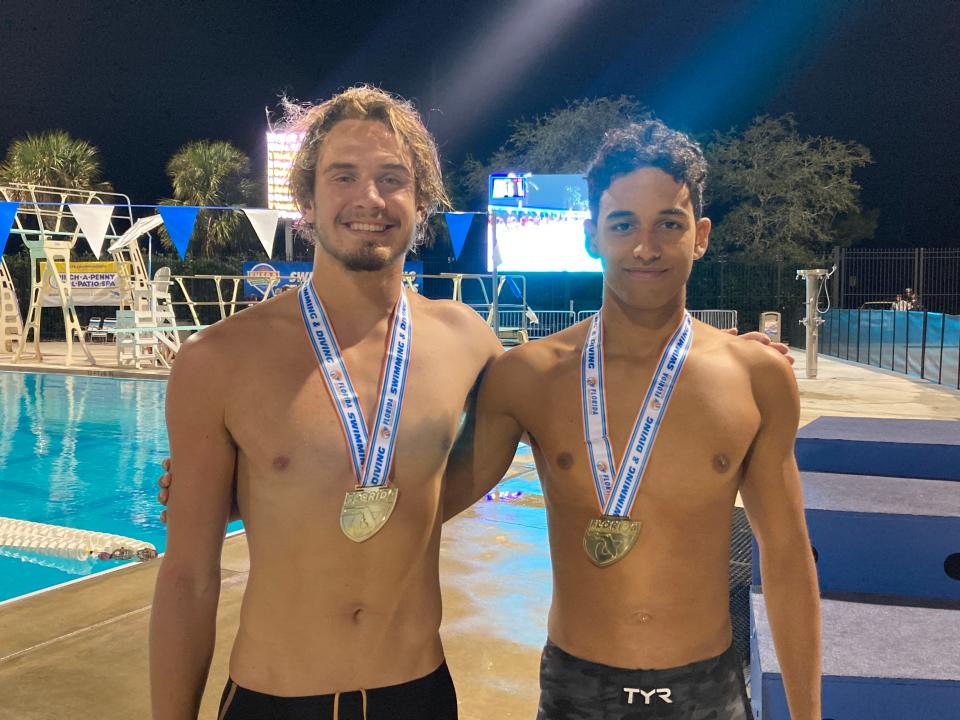 Defending 200-meter free champions senior Gregory Nordheim (left) and junior Marcus Johnson (right) of Boca Raton pose with their gold medals.