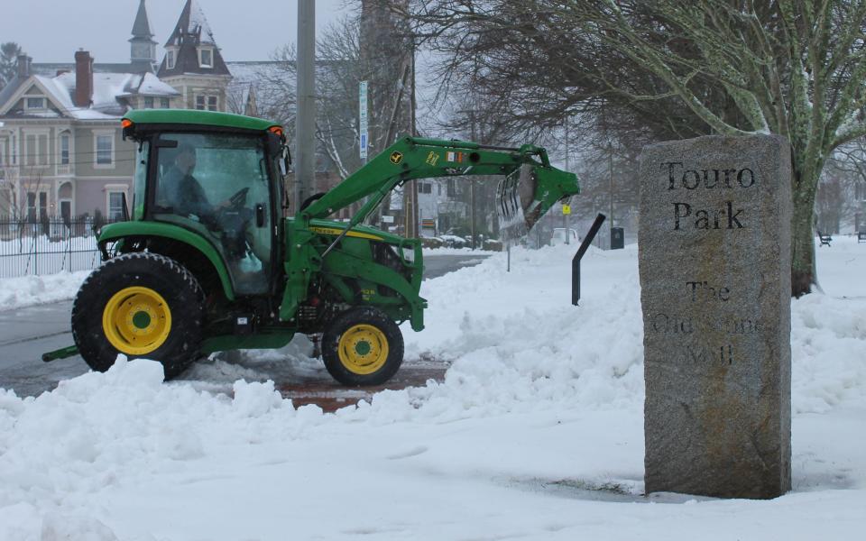 A tractor removes snow near Touro Park in Newport in Dec. 2020.