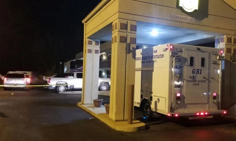 A Georgia Bureau of Investigation Crime Lab vehicle is parked outside a Banks Crossing motel in Commerce where a deputy, a kidnapping suspect and his victim were wounded in a shootout Tuesday.