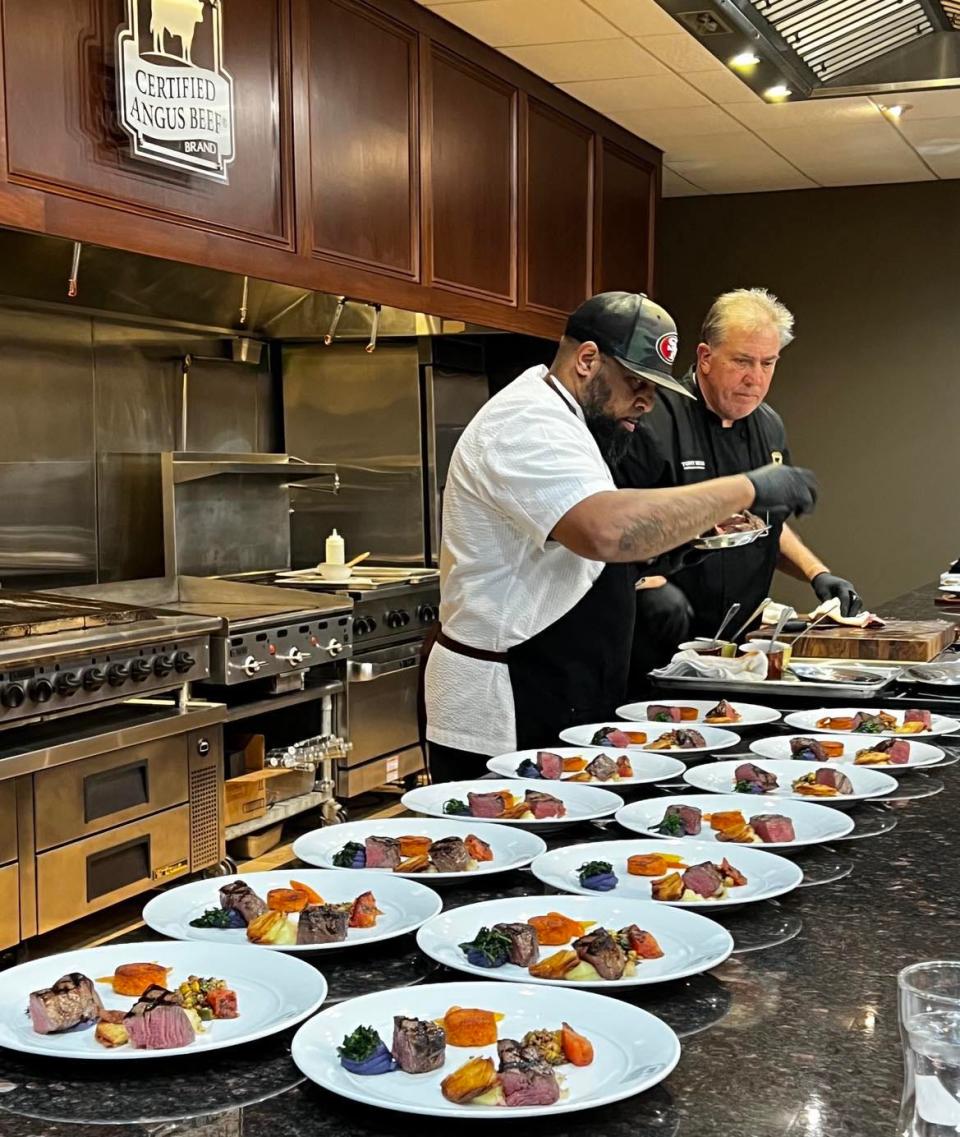 Executive Chef Venoy Rogers III and Chef Tony Biggs, both of Certified Angus Beef in Wooster, prepare meals during a sampling for dishes that were considered for the Pro Football Hall of Fame Enshrinement Festival's Gold Jacket Dinner.