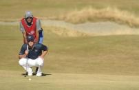 Jun 21, 2015; University Place, WA, USA; Jordan Spieth and caddie Michael Greller line up a putt on the 14th green in the final round of the 2015 U.S. Open golf tournament at Chambers Bay. Mandatory Credit: John David Mercer-USA TODAY Sports