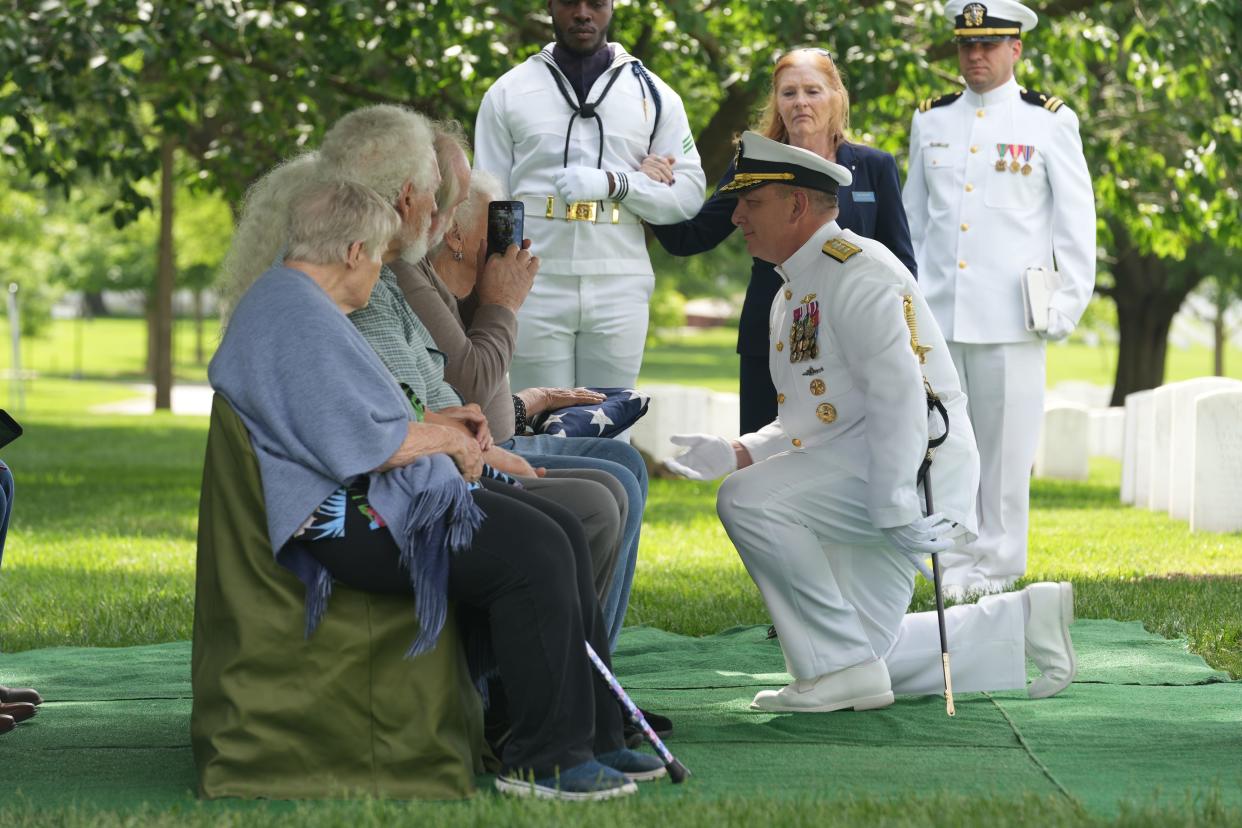 Rear Admiral Scott Pappano hands a flag to the family members of Frank Hryniewicz who was laid to rest at Arlington National Cemetery on May 16, 2024 in Arlington, Va. Hryniewicz, 20, was aboard the USS Oklahoma when Japan attacked Pearl Harbor on Dec. 7, 1941.