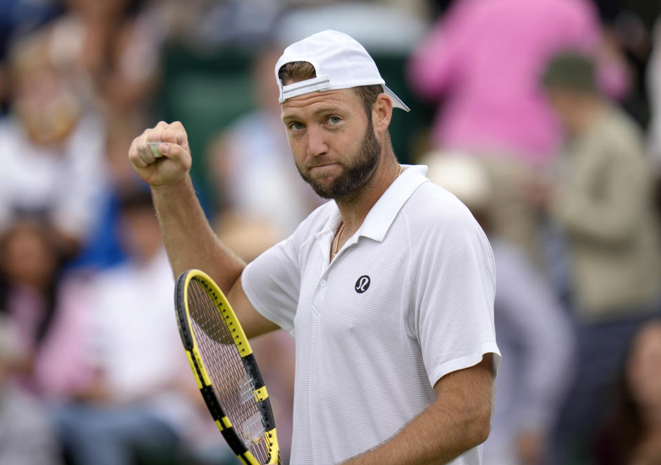 Jack Sock of the US celebrates beating Maxime Cressy of the US in their men's second round singles match on day five of the Wimbledon tennis championships in London, Friday, July 1, 2022. (AP Photo/Kirsty Wigglesworth)