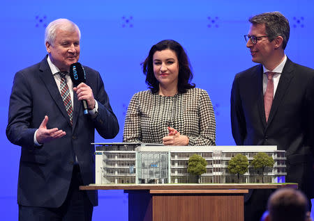 Horst Seehofer, outgoing leader of the Christian Social Union (CSU) receives a miniature party headquarters as a farewell gift from German Minister of State Dorothee Baer and Secretary General of the CSU Markus Blume, during the party meeting in Munich, Germany, January 19, 2019. REUTERS/Andreas Gebert