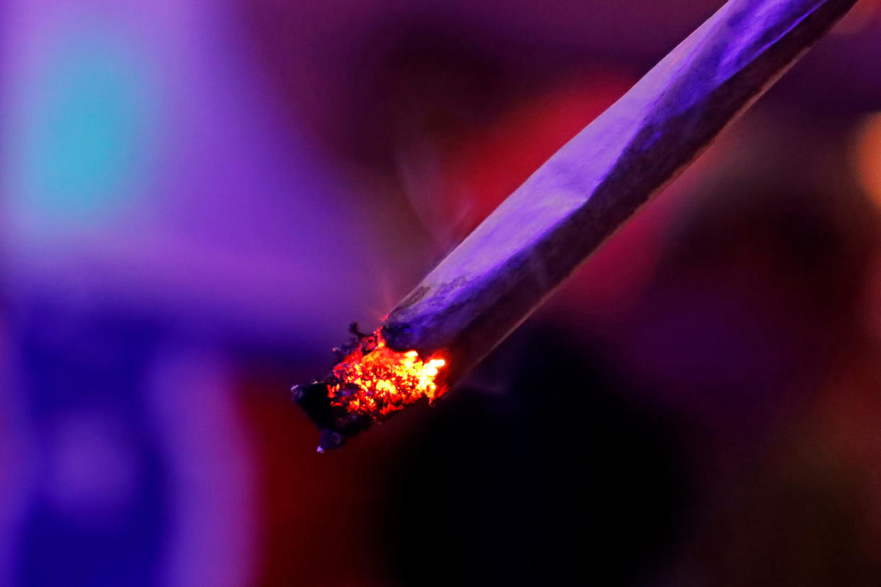 A person smokes a joint  (Rapeepong Puttakumwong / Getty Images)