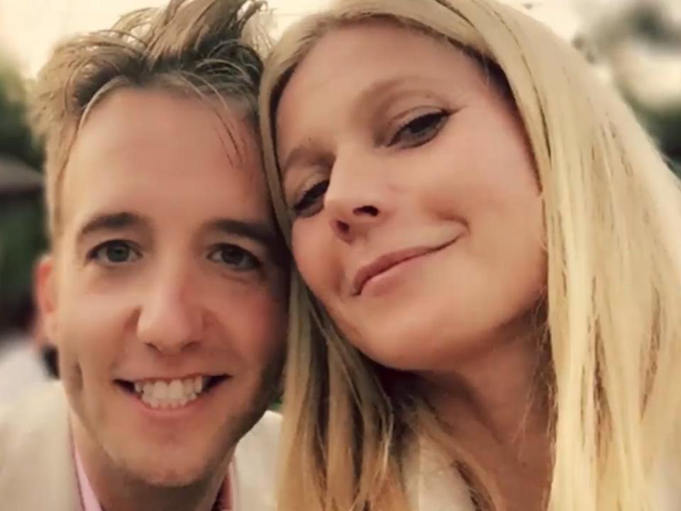 A man and a woman lean their heads together and smile in a selfie.