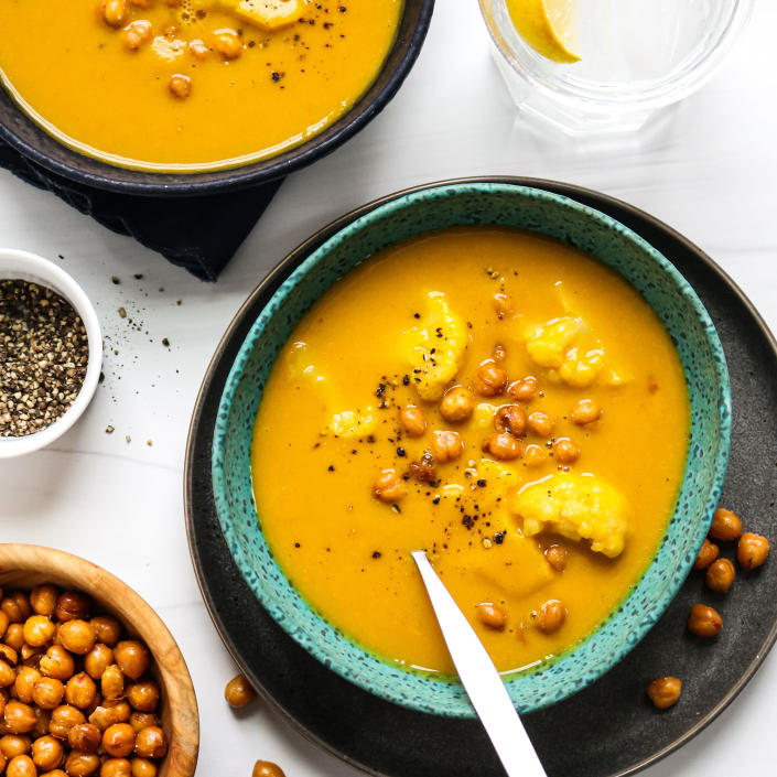 <p>Bulk up boxed butternut squash soup with frozen cauliflower florets, then top off your bowl with crispy chickpea snacks for major crunch (look for them near the dried fruit and nuts at your grocery store). This impressively easy dinner comes together with just those three ingredients, not including salt, pepper and oil. Because prepared soups are typically higher in sodium, look for light or reduced-sodium versions of your favorites. <a href="https://www.eatingwell.com/recipe/7886572/butternut-squash-kale-soup-with-chickpea-croutons/" rel="nofollow noopener" target="_blank" data-ylk="slk:View Recipe" class="link rapid-noclick-resp">View Recipe</a></p>
