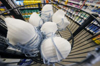 A product stall filled with free N95 respirator masks, provided by the U.S. Department of Health and Human Services, sits outside the pharmacy at this Jackson, Miss., Kroger grocery store, Wednesday, Feb. 2, 2022. Americans who have been clamoring for an end to mask-wearing have welcomed new guidance from the Centers for Disease Control and Prevention. It says healthy people in most areas of the country can safely stop wearing masks. But others remain wary that the pandemic could throw a new curveball. (AP Photo/Rogelio V. Solis)