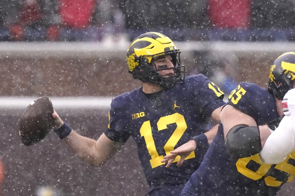 Michigan quarterback Cade McNamara (12) throws during the first half of an NCAA college football game against Ohio State, Saturday, Nov. 27, 2021, in Ann Arbor, Mich. (AP Photo/Carlos Osorio)